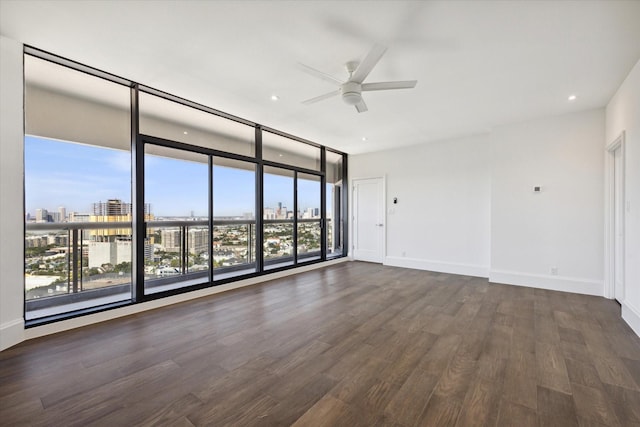 1701 Hermann Dr Unit 27Ce, Houston, TX 77004 - unfurnished room with ceiling fan, dark wood-style floors, a city view, baseboards, and expansive windows