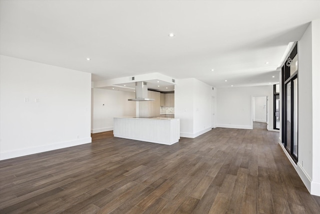 1701 Hermann Dr Unit 27Ce, Houston, TX 77004 - unfurnished living room with dark wood-style flooring, recessed lighting, and baseboards