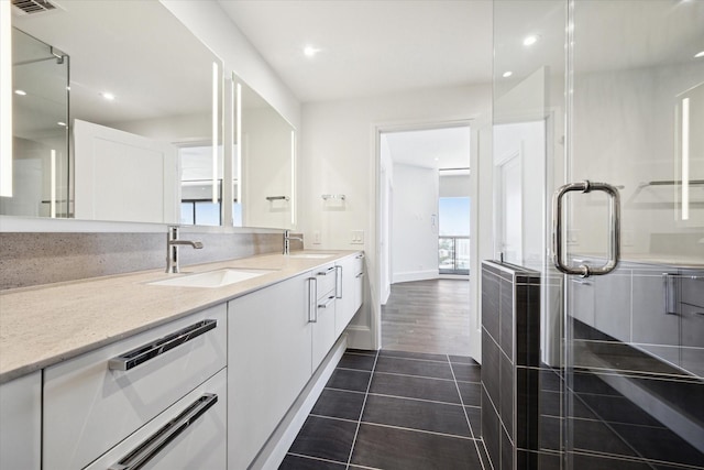 1701 Hermann Dr Unit 27Ce, Houston, TX 77004 - bathroom with double vanity, recessed lighting, tile patterned flooring, a stall shower, and baseboards