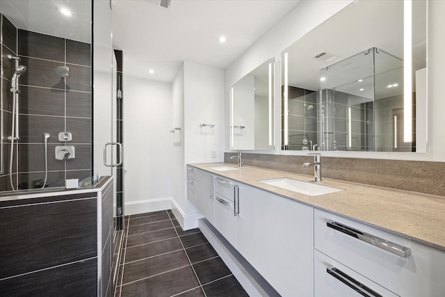 1701 Hermann Dr Unit 27Ce, Houston, TX 77004 - full bath featuring double vanity, a shower stall, baseboards, tile patterned flooring, and recessed lighting