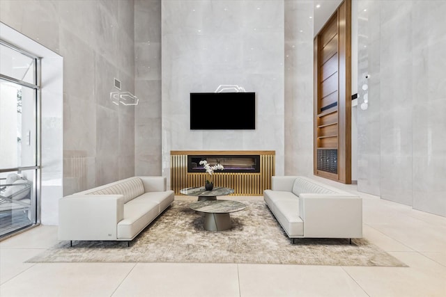 1701 Hermann Dr Unit 27Ce, Houston, TX 77004 - tiled living room with a glass covered fireplace and tile walls