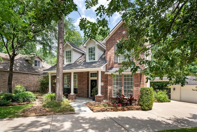 38 Agate Stream Pl, The Woodlands, TX 77381 - view of front of house featuring brick siding and driveway