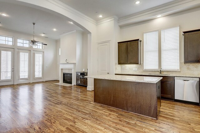 9622 Fannin Sta W, Houston, TX 77045 - kitchen with dishwasher, a sink, ceiling fan, ornamental molding, and a fireplace with flush hearth