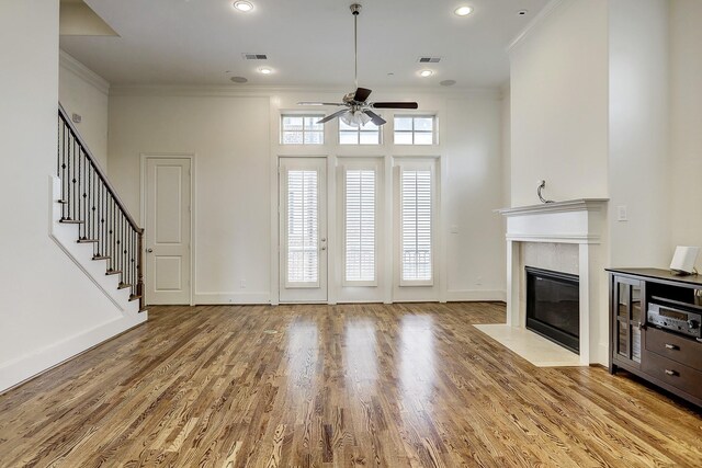 9622 Fannin Sta W, Houston, TX 77045 - unfurnished living room with ornamental molding, ceiling fan, a premium fireplace, wood finished floors, and baseboards