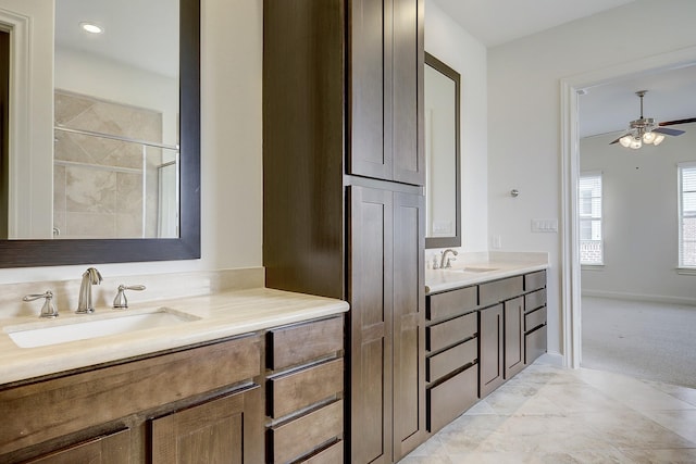 9622 Fannin Sta W, Houston, TX 77045 - full bathroom with two vanities, a ceiling fan, tiled shower, and baseboards