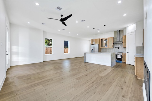 5107 New Orleans St, Houston, TX 77020 - unfurnished living room with recessed lighting, light wood-style flooring, ceiling fan, and baseboards