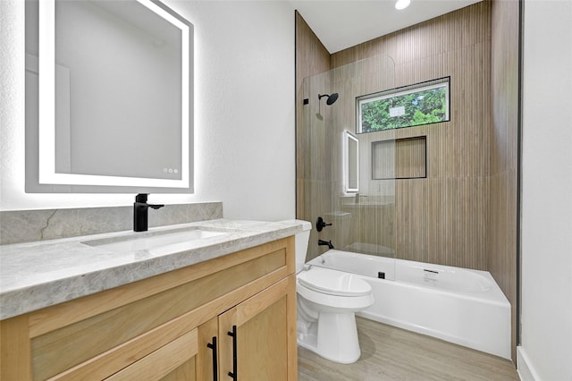 5107 New Orleans St, Houston, TX 77020 - full bathroom featuring vanity, toilet, wood finished floors, and  shower combination