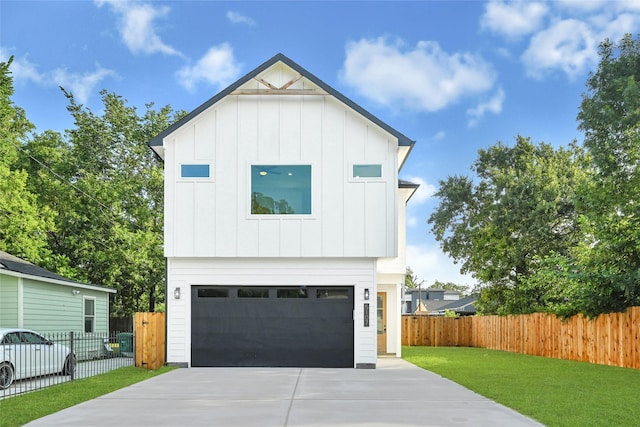 5107 New Orleans St, Houston, TX 77020 - view of front of house with board and batten siding, driveway, and an attached garage