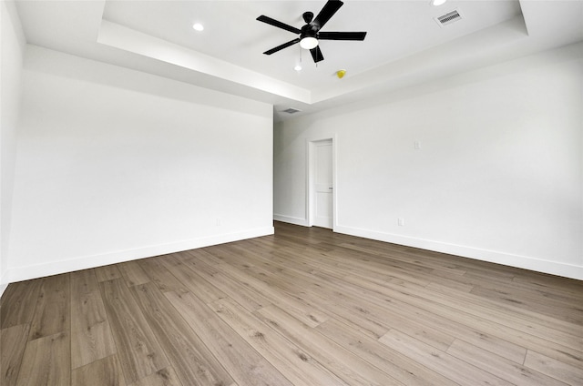 5107 New Orleans St, Houston, TX 77020 - empty room with a raised ceiling, baseboards, wood finished floors, and recessed lighting
