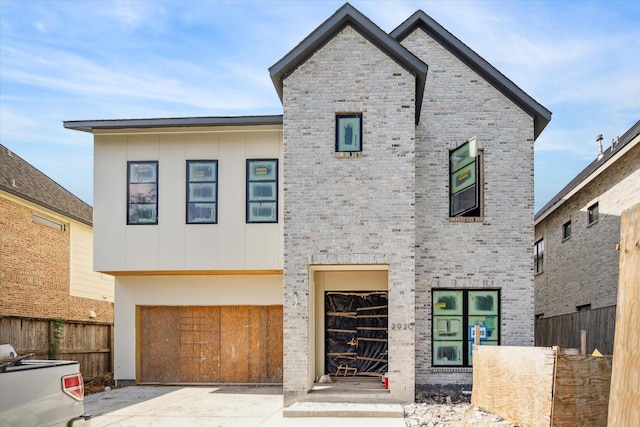 2920 Georgetown St, Houston, TX 77005 - modern home with board and batten siding, a garage, and stone siding