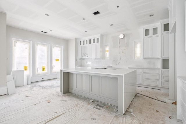 2920 Georgetown St, Houston, TX 77005 - kitchen featuring white cabinetry, a center island, glass insert cabinets, and light countertops