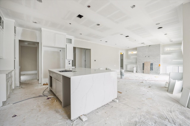 2920 Georgetown St, Houston, TX 77005 - kitchen featuring a large island, light stone counters, white cabinets, and open floor plan