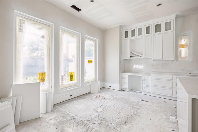 2920 Georgetown St, Houston, TX 77005 - kitchen with white cabinetry, glass insert cabinets, and light countertops