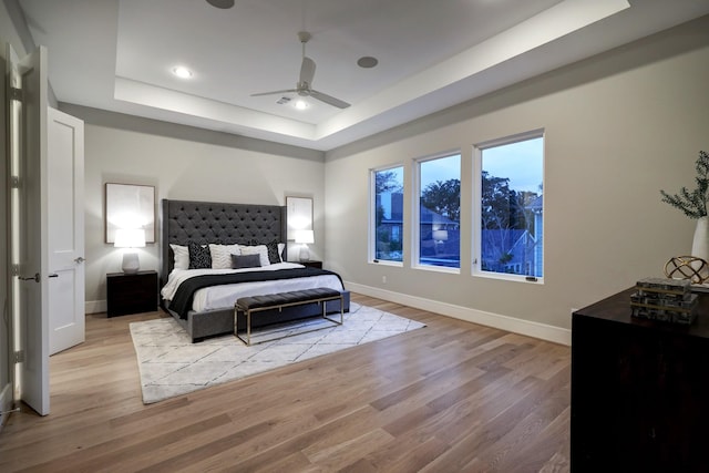 2920 Georgetown St, Houston, TX 77005 - bedroom featuring a tray ceiling, light wood-type flooring, baseboards, recessed lighting, and ceiling fan