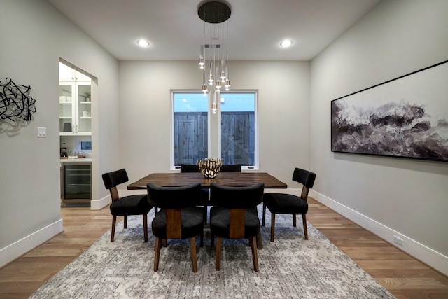 2920 Georgetown St, Houston, TX 77005 - dining room featuring wine cooler, baseboards, light wood-style floors, and recessed lighting