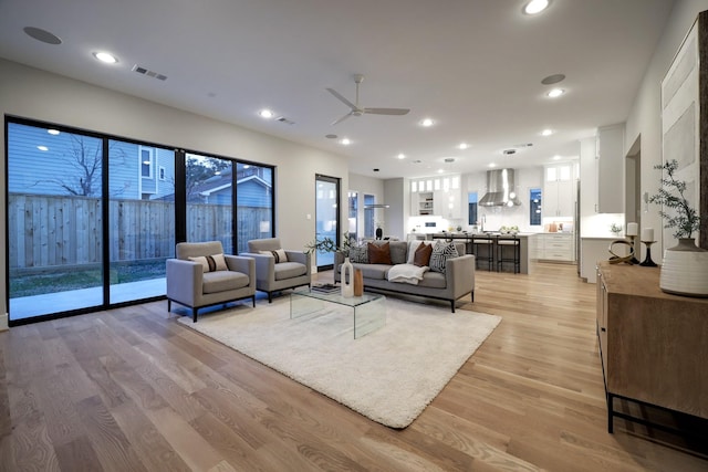 2920 Georgetown St, Houston, TX 77005 - living room with a ceiling fan, light wood-style floors, healthy amount of natural light, and recessed lighting
