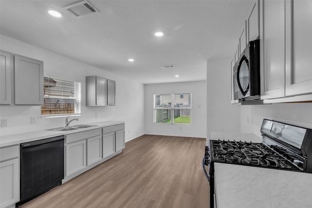 4625 Peralta Heights Way, Porter, TX 77365 - kitchen featuring stainless steel gas stove, dishwasher, light wood-type flooring, light countertops, and recessed lighting