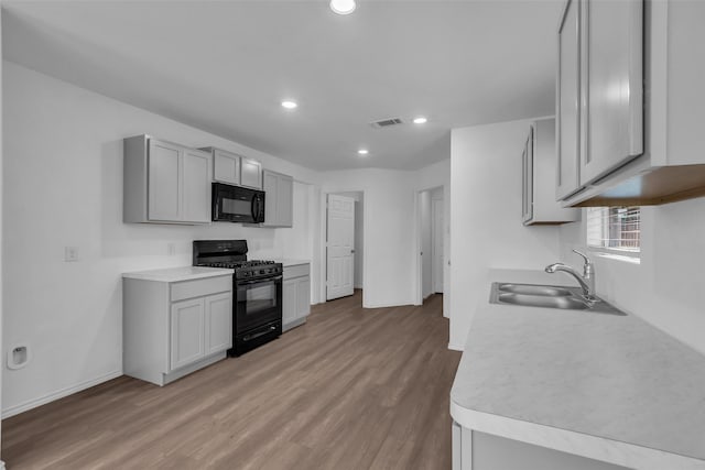 4625 Peralta Heights Way, Porter, TX 77365 - kitchen featuring black appliances, light wood-type flooring, light countertops, recessed lighting, and gray cabinetry