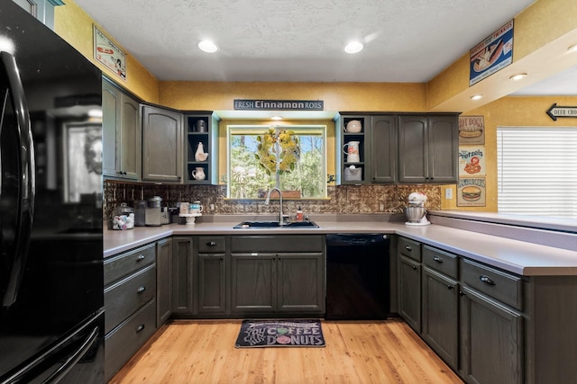 3027 Pine Acres Dr, Conroe, TX 77384 - kitchen with black appliances, open shelves, a sink, a peninsula, and recessed lighting