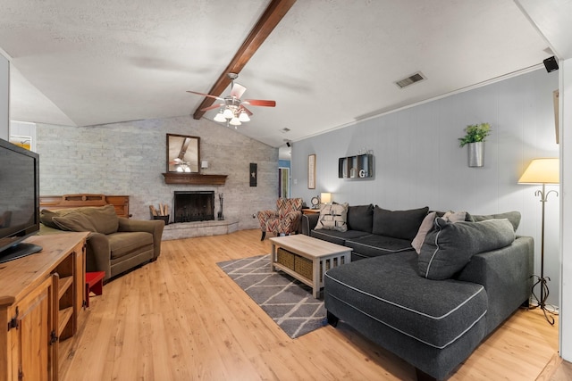 3027 Pine Acres Dr, Conroe, TX 77384 - living area featuring ceiling fan, wood finished floors, and a fireplace