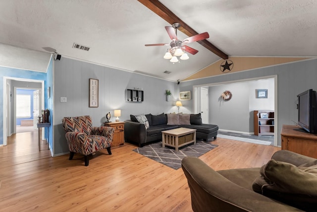 3027 Pine Acres Dr, Conroe, TX 77384 - living room with light wood-type flooring, ceiling fan, and a textured ceiling