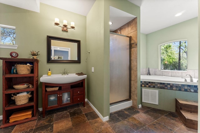 3027 Pine Acres Dr, Conroe, TX 77384 - full bathroom with plenty of natural light, a stall shower, and a garden tub