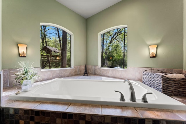 3027 Pine Acres Dr, Conroe, TX 77384 - bathroom featuring healthy amount of natural light, a garden tub, and vaulted ceiling