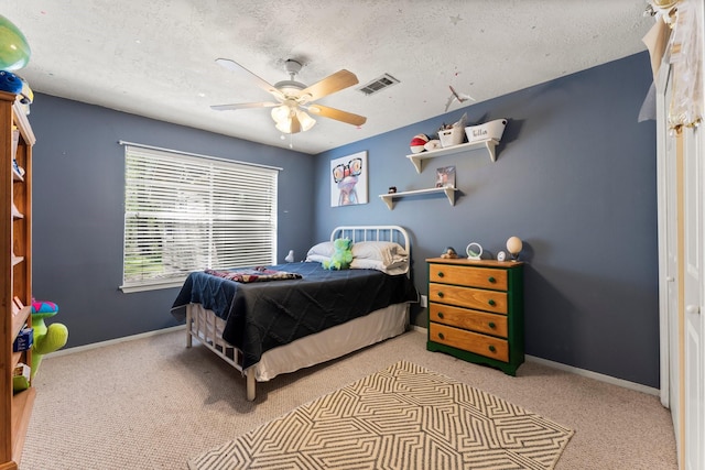 3027 Pine Acres Dr, Conroe, TX 77384 - carpeted bedroom with a ceiling fan, baseboards, and a textured ceiling