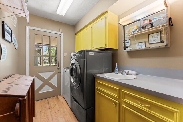 3027 Pine Acres Dr, Conroe, TX 77384 - washroom with cabinet space, independent washer and dryer, and light wood finished floors
