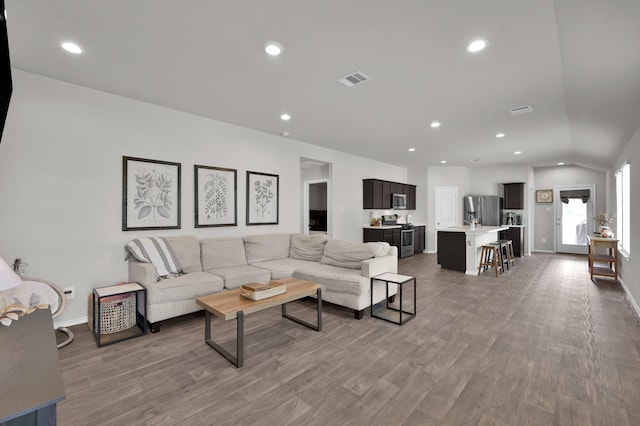 13916 Great Pines Ct, Conroe, TX 77302 - living room featuring wood finished floors, baseboards, lofted ceiling, and recessed lighting