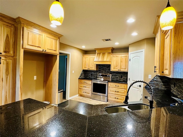 304 Ashwood Bnd, Hudson, TX 75904 - kitchen with stainless steel range, a sink, premium range hood, baseboards, and decorative backsplash