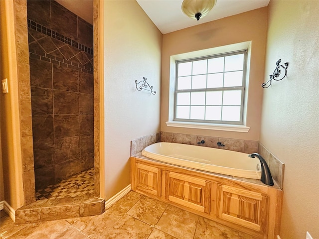 304 Ashwood Bnd, Hudson, TX 75904 - full bath with a garden tub, a tile shower, and baseboards