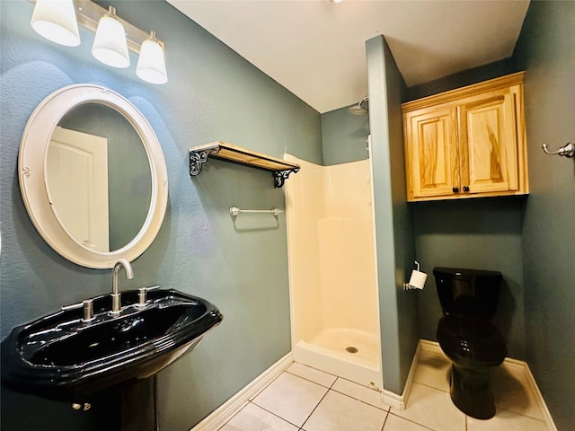 304 Ashwood Bnd, Hudson, TX 75904 - full bath featuring tile patterned flooring, baseboards, a stall shower, toilet, and a sink