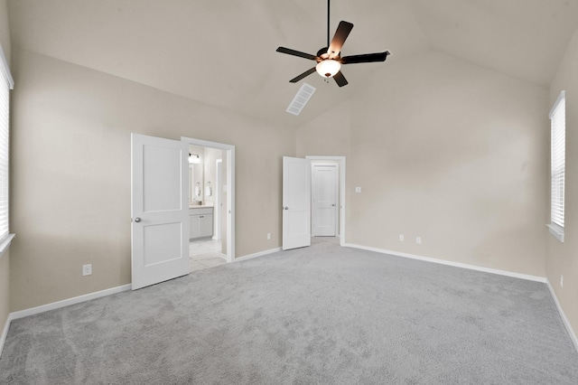 308 N Spotted Fern Dr, Montgomery, TX 77316 - unfurnished bedroom with light carpet, multiple windows, baseboards, and high vaulted ceiling