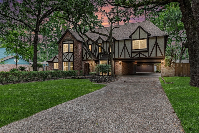 6307 Bayonne Dr, Spring, TX 77389 - english style home featuring asphalt driveway, a shingled roof, a carport, and brick siding