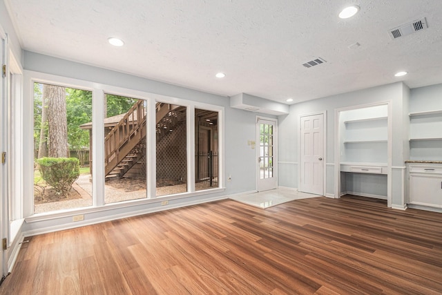 6307 Bayonne Dr, Spring, TX 77389 - foyer entrance featuring baseboards, wood finished floors, a textured ceiling, recessed lighting, and plenty of natural light