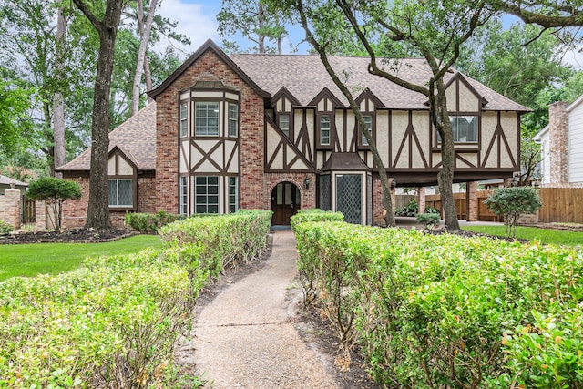 6307 Bayonne Dr, Spring, TX 77389 - english style home with a shingled roof, brick siding, and stucco siding