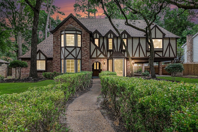 6307 Bayonne Dr, Spring, TX 77389 - english style home with a shingled roof, brick siding, and stucco siding