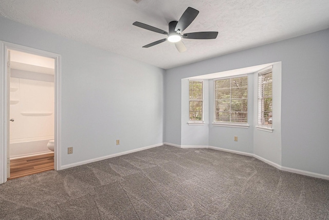 6307 Bayonne Dr, Spring, TX 77389 - spare room with carpet floors, a textured ceiling, a ceiling fan, and baseboards