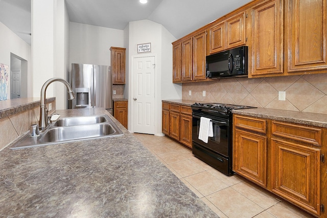 17206 Kobuk Valley Cir, Humble, TX 77346 - kitchen featuring black appliances, a sink, brown cabinets, tasteful backsplash, and vaulted ceiling