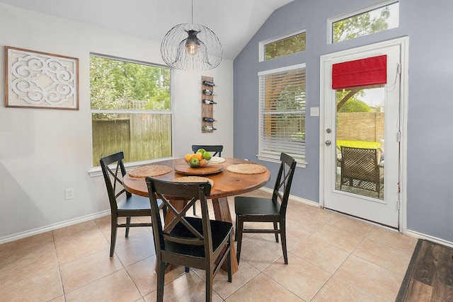 17206 Kobuk Valley Cir, Humble, TX 77346 - dining space with lofted ceiling, a chandelier, light tile patterned floors, and baseboards