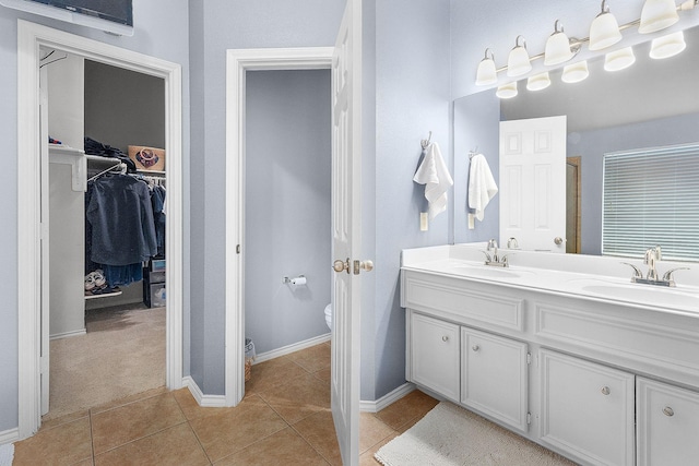 17206 Kobuk Valley Cir, Humble, TX 77346 - full bath with a walk in closet, a stall shower, double vanity, tile patterned floors, and toilet