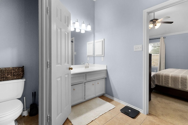 17206 Kobuk Valley Cir, Humble, TX 77346 - ensuite bathroom with vanity, ceiling fan, toilet, tile patterned flooring, and baseboards