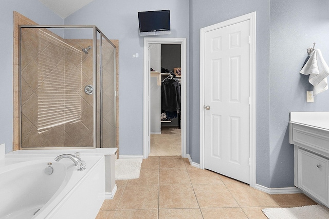 17206 Kobuk Valley Cir, Humble, TX 77346 - full bath featuring a stall shower, vanity, a garden tub, tile patterned floors, and a walk in closet
