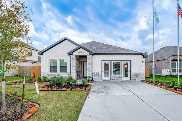 26414 Cooperstown Way, Splendora, TX 77372 - view of front of house featuring stone siding, roof with shingles, concrete driveway, and brick siding