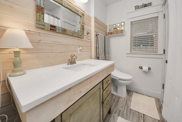1038 Lawrence St, Houston, TX 77008 - bathroom featuring vanity, wood finished floors, wooden walls, and a shower with curtain