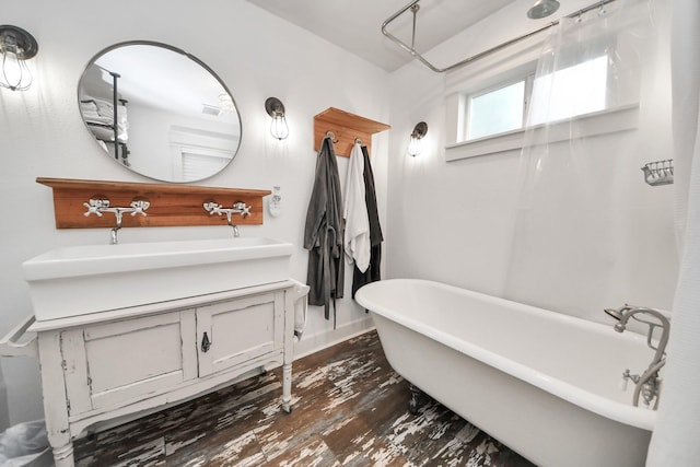 1038 Lawrence St, Houston, TX 77008 - bathroom with a freestanding tub, vanity, and wood finished floors