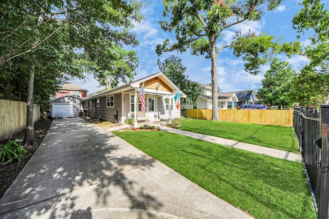 1038 Lawrence St, Houston, TX 77008 - view of front of house with driveway, an outbuilding, a detached garage, and a porch