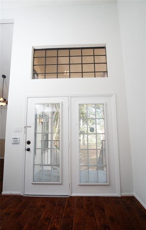 16800 Sugar Pine Dr Unit F44, Houston, TX 77090 - doorway with dark wood-type flooring, baseboards, and a high ceiling