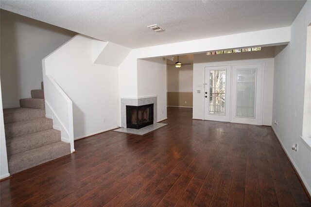 16800 Sugar Pine Dr Unit F44, Houston, TX 77090 - unfurnished living room with dark wood-style floors, stairway, baseboards, a high end fireplace, and ceiling fan